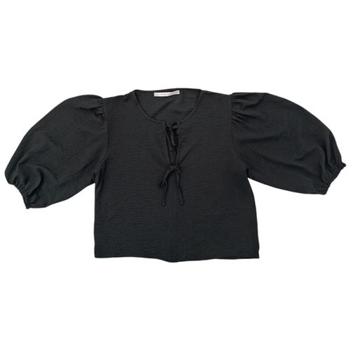 Blusa color negro con detalles de lazas para mujer